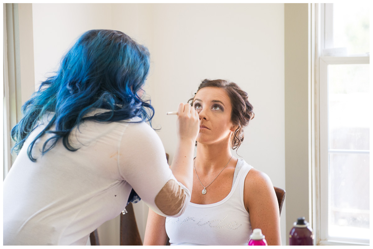 bride getting make up done for farm wedding