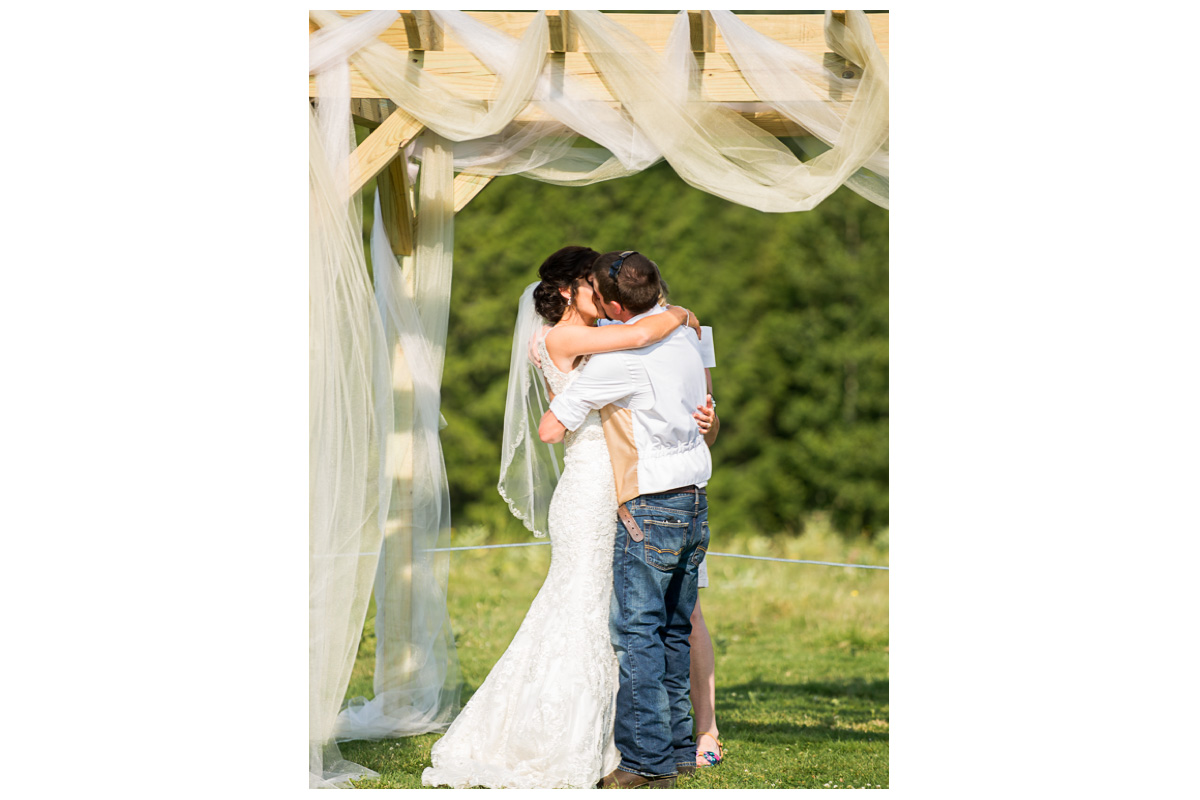 bride and groom kissing at ceremony