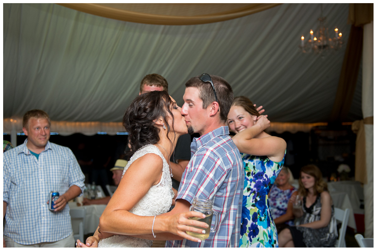 bride and groom kissing at the end of wedding reception