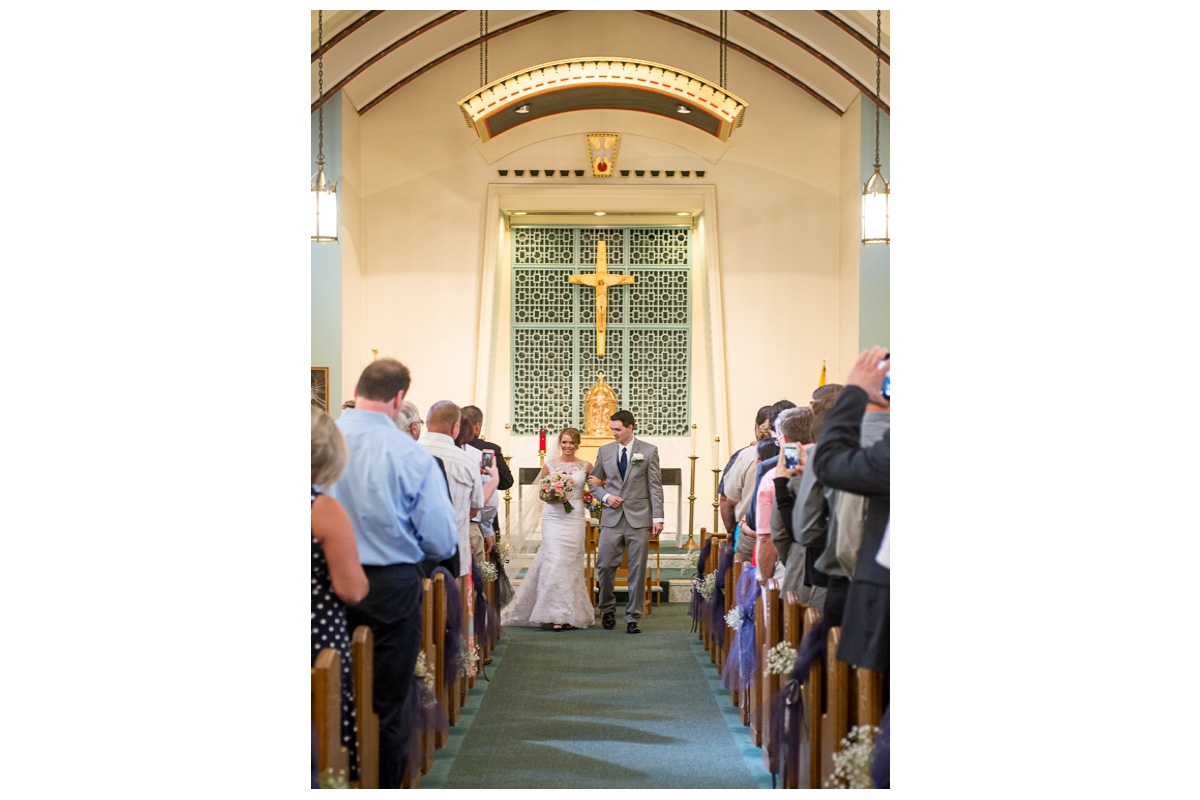 bride and groom walking down the aisle after church ceremony