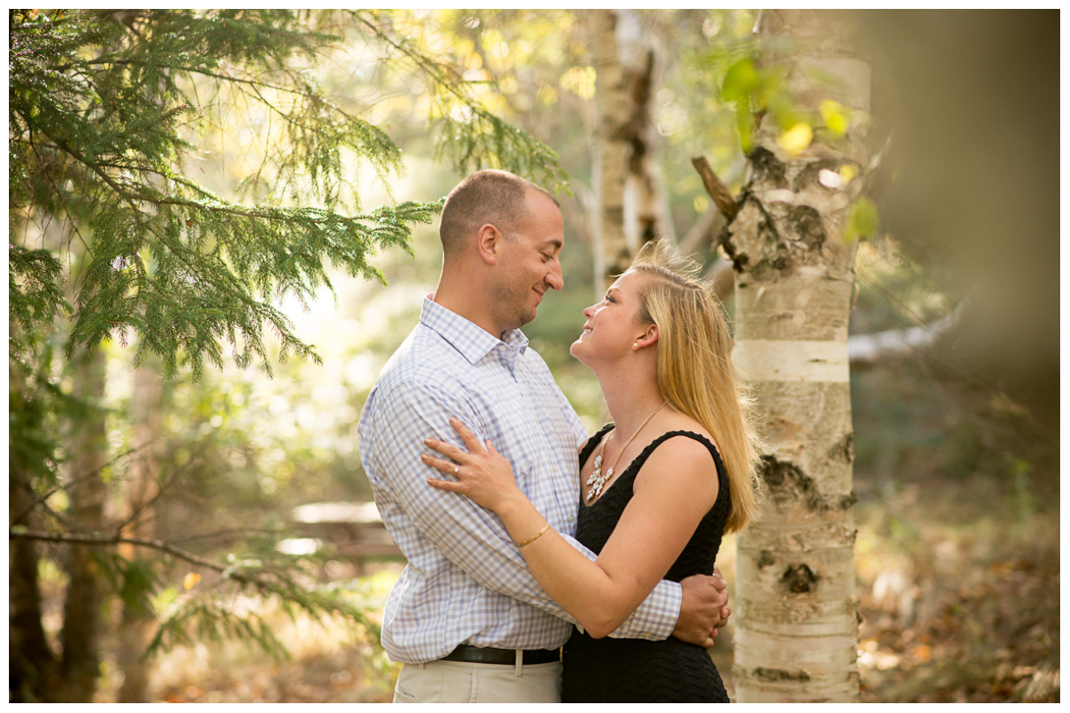 engaged couple dressed up in woods