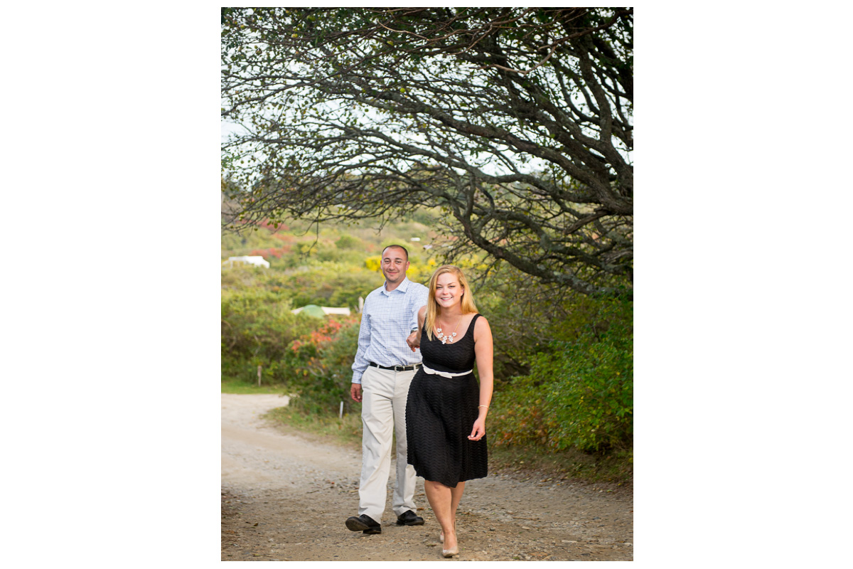 couple laughing while walking for engagement photos