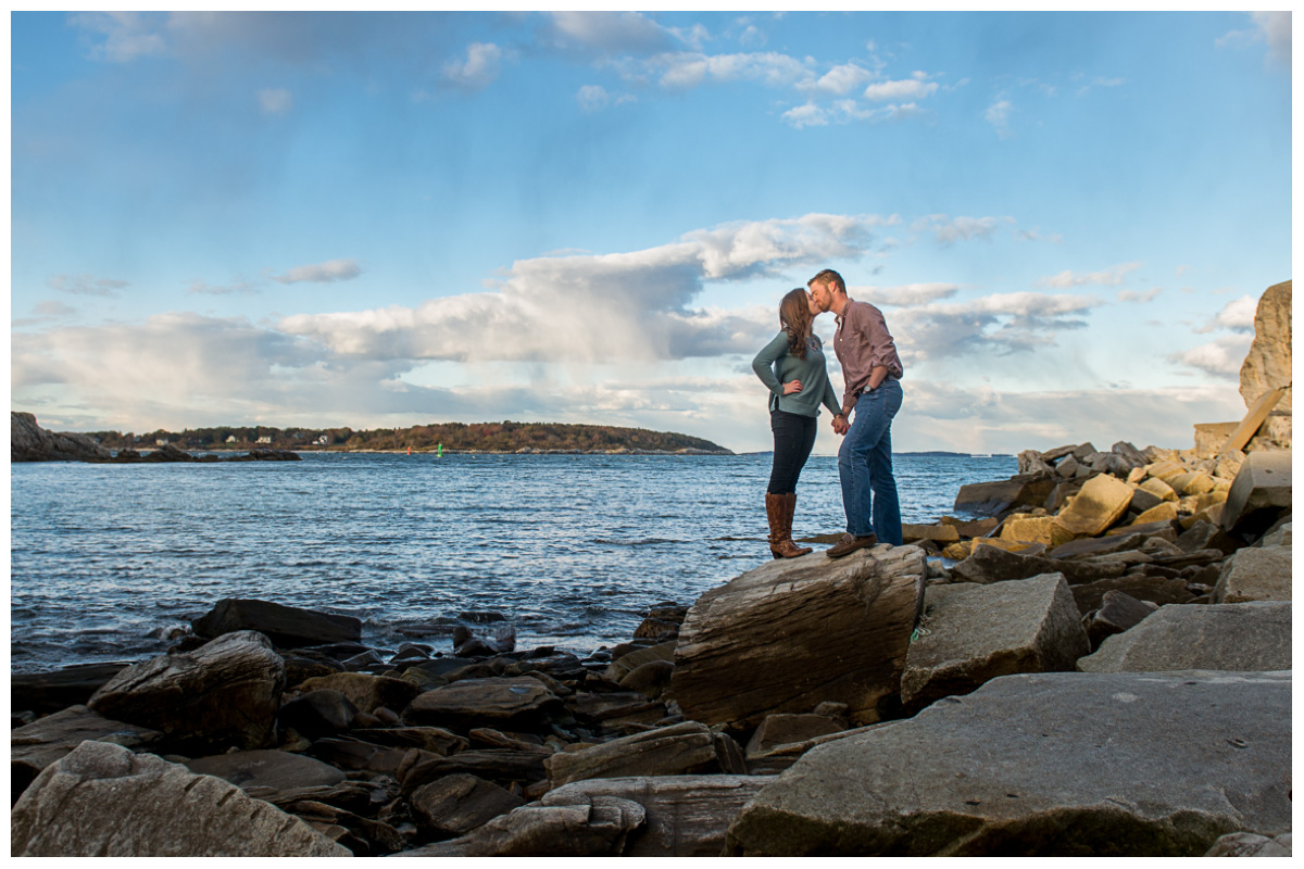 Engagement photos with couple on rocks with the ocean