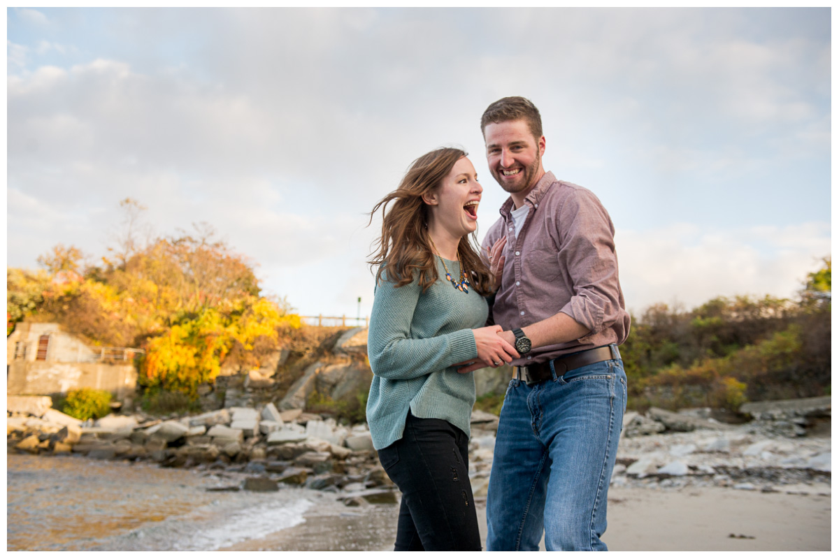 couple laughing during engagement photos at fort williams