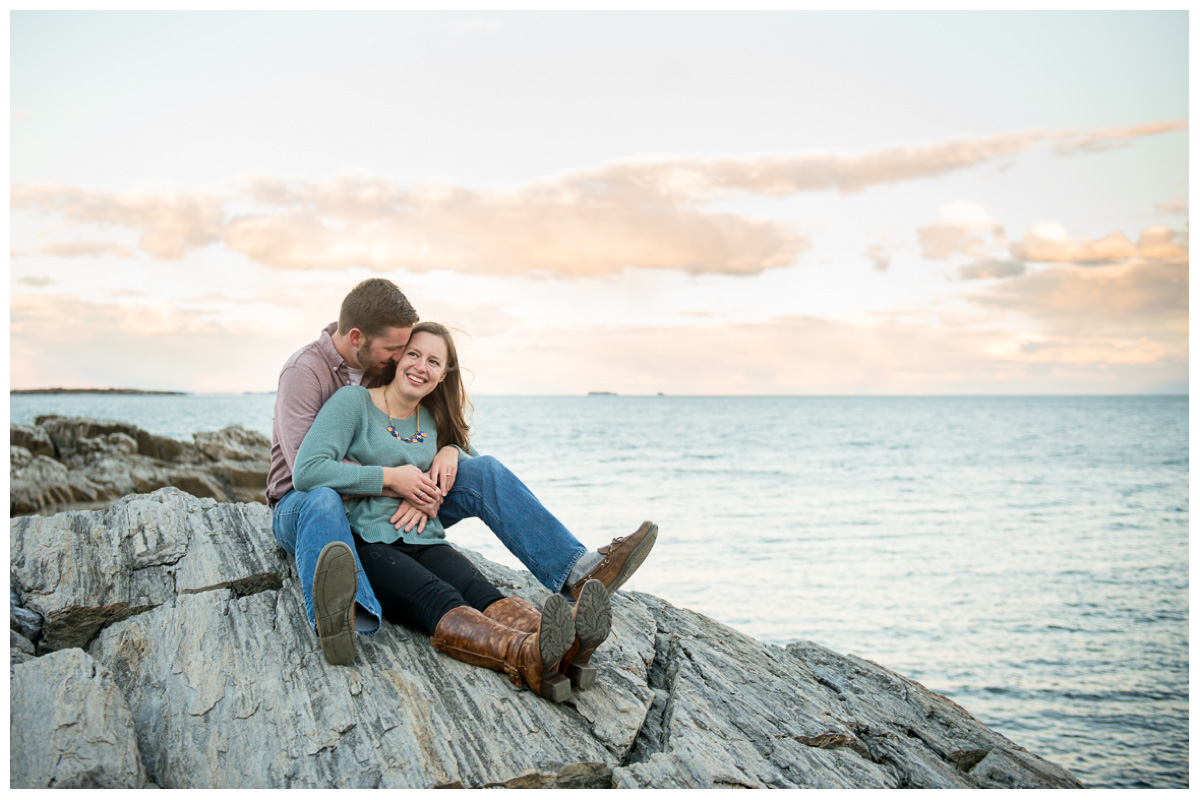 kissing couple on rocks by the ocean in Maine