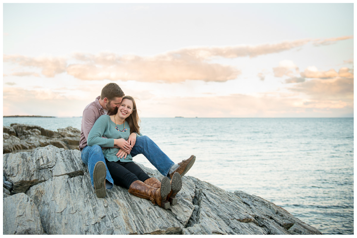 kissing couple on rocks by the ocean in Maine