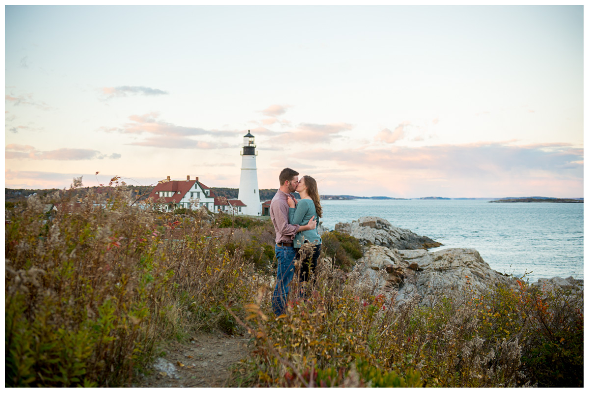 couple kissing at Portland Head Light at sunset