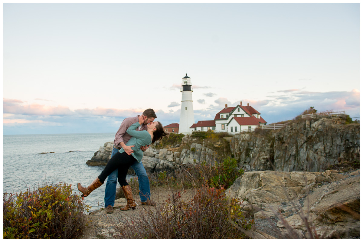 Engaged couple kissing at Portland Head Light in Cape Elizabeth