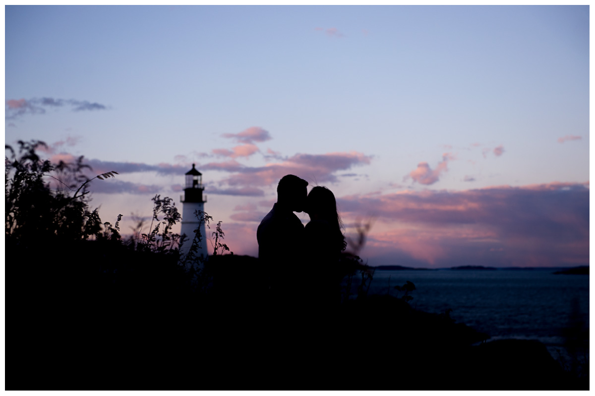 Silhouette of engaged couple at Portland Head Light in Maine