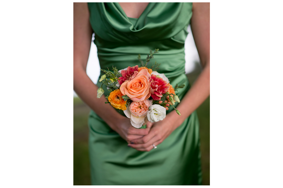 green bridesmaids dresses with coral colored bouquet 
