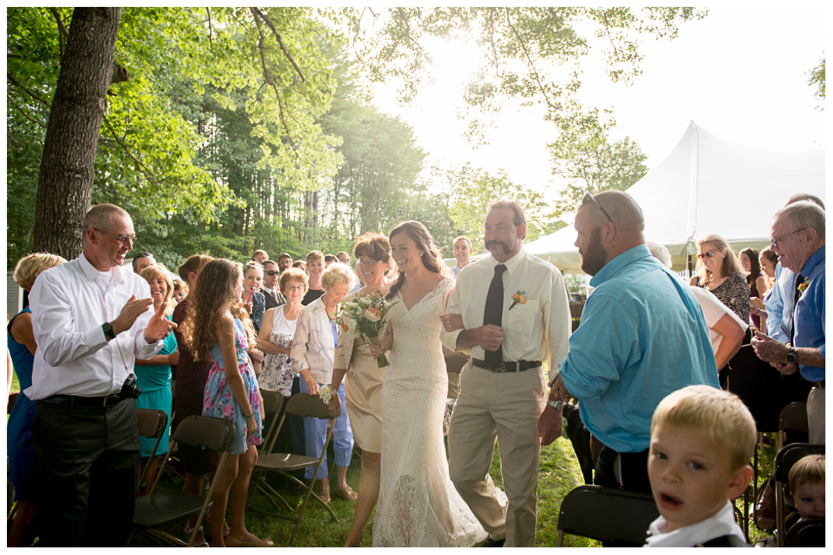 bride walking down the aisle during outdoor wedding ceremony