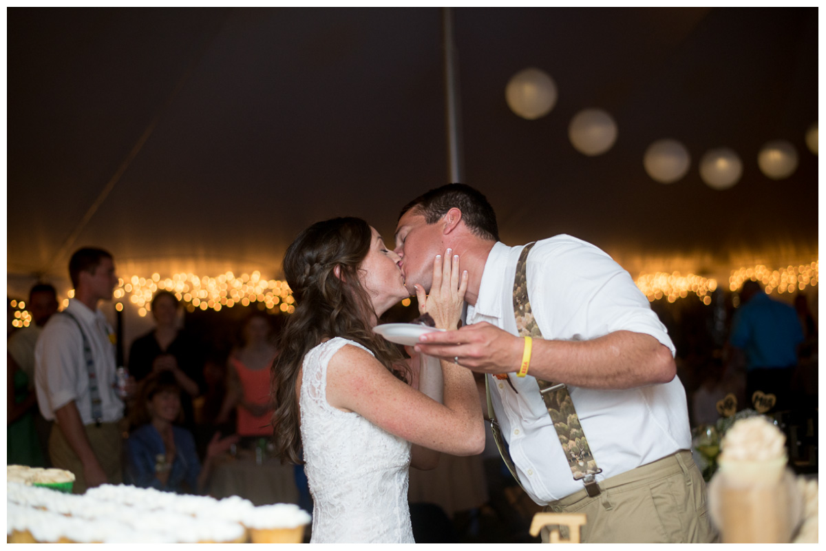 bride and groom kissing at tented reception