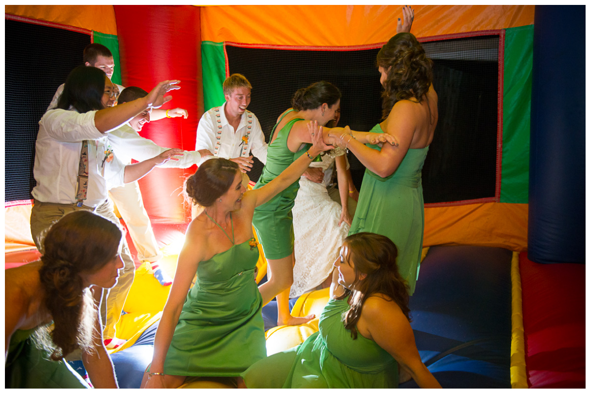 wedding party in bouncy house at wedding reception