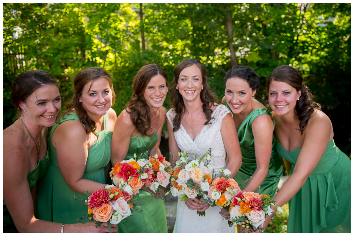 bride with bridesmaids next to river in newmarket