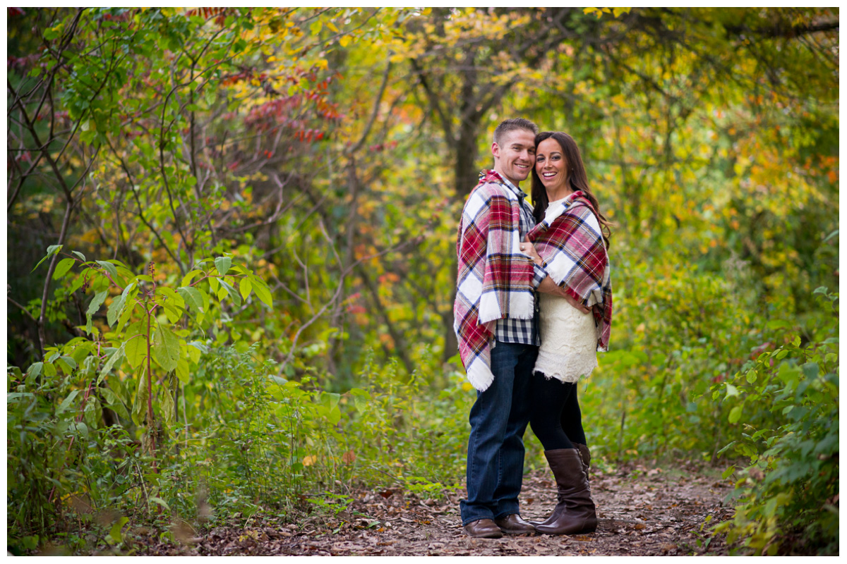couple wrapped in blanket for engagement photos