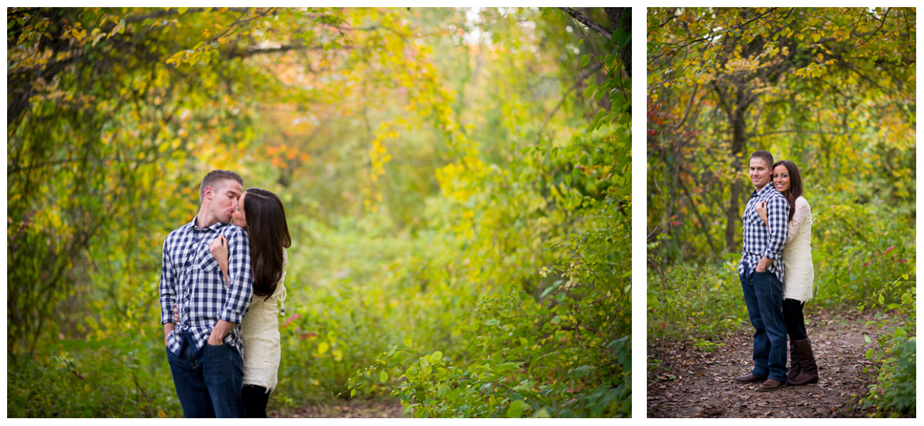 engaged couple kissing in the woods 