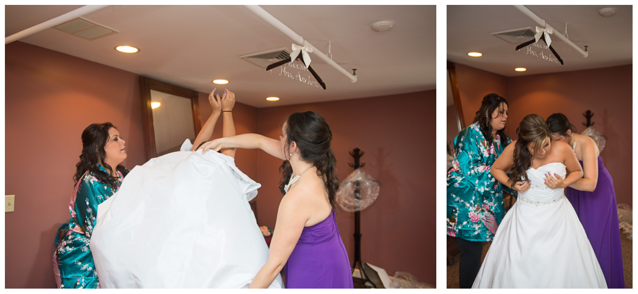 bride getting into wedding dress with bridesmaids