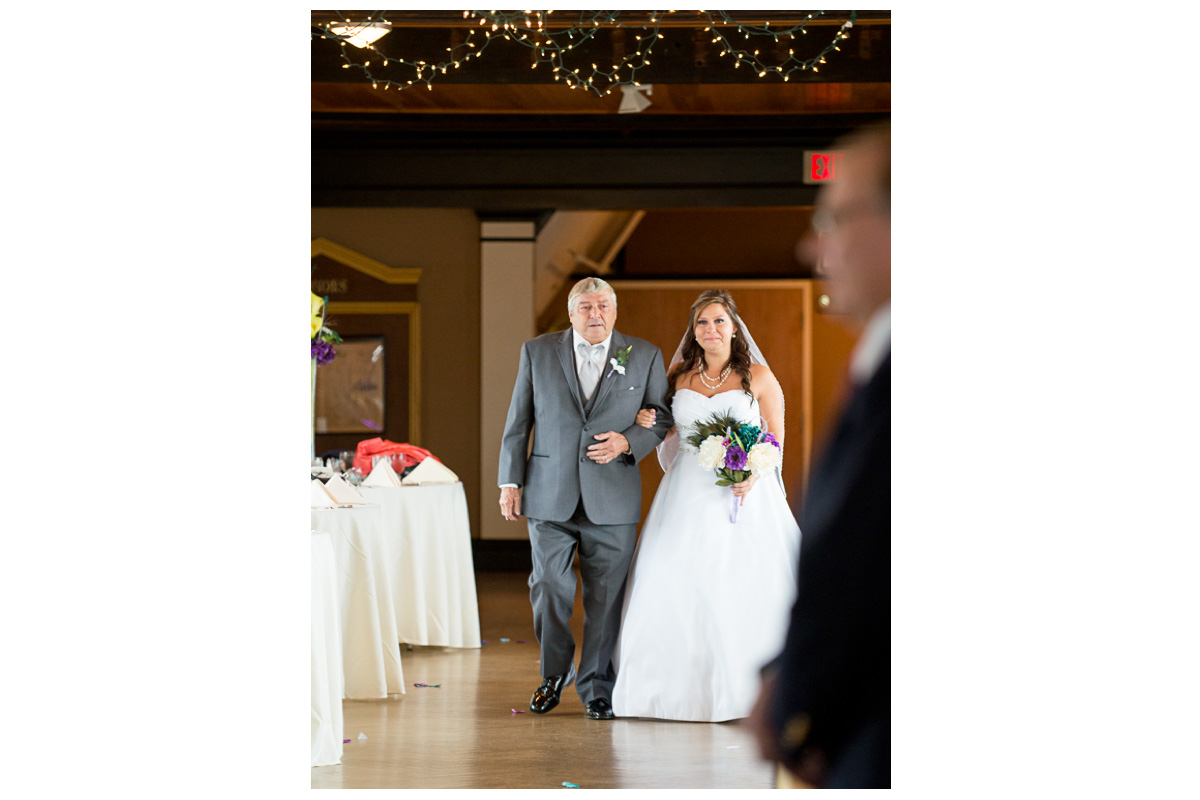 bride walking down the aisle with father in the Towers