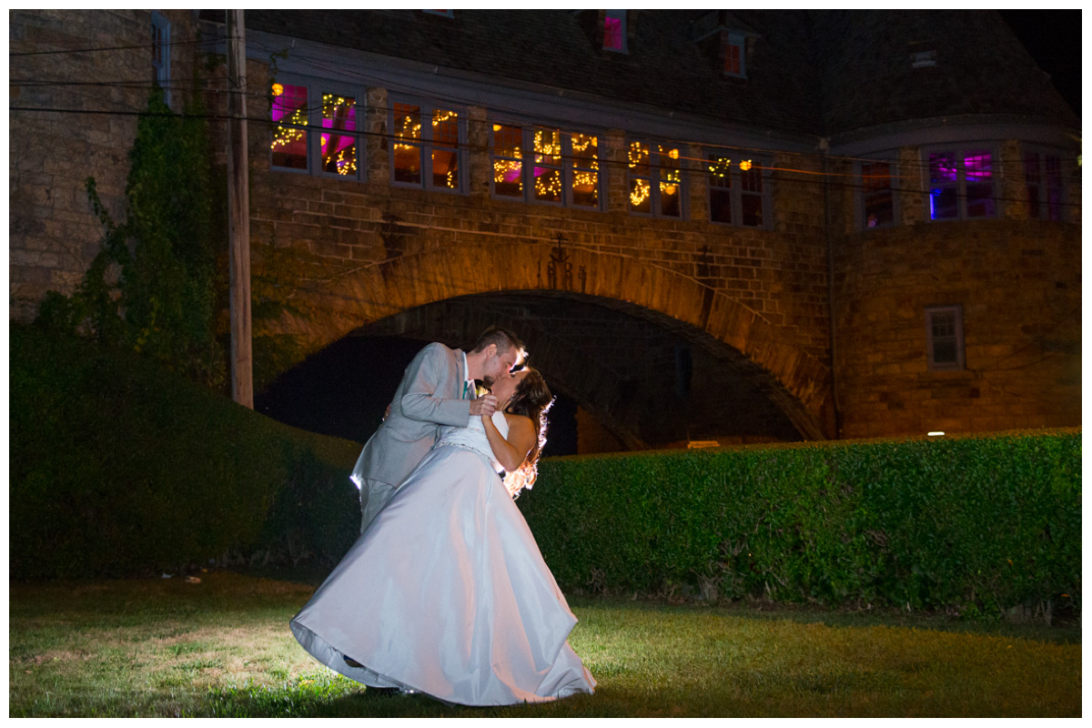 bride and groom kissing in front of the Towers in Narragansett Rhode Island