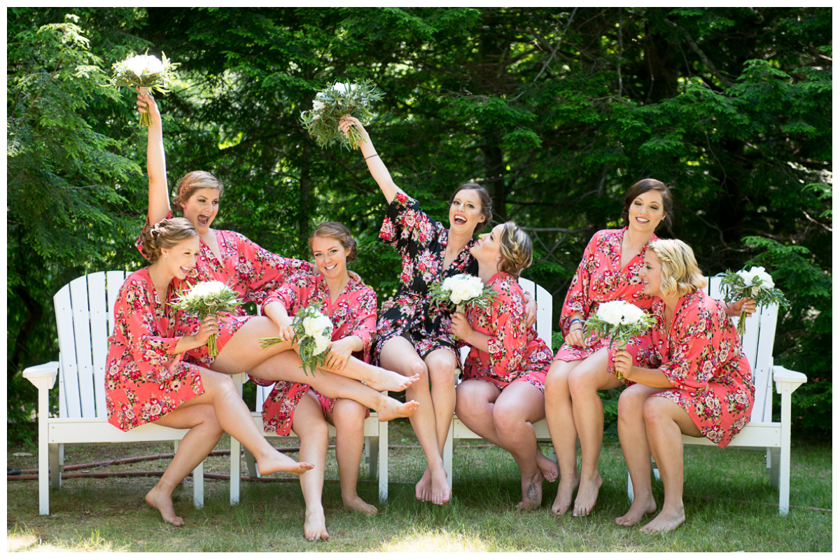 happy and fun bridesmaids with bride on wedding day in flower robes