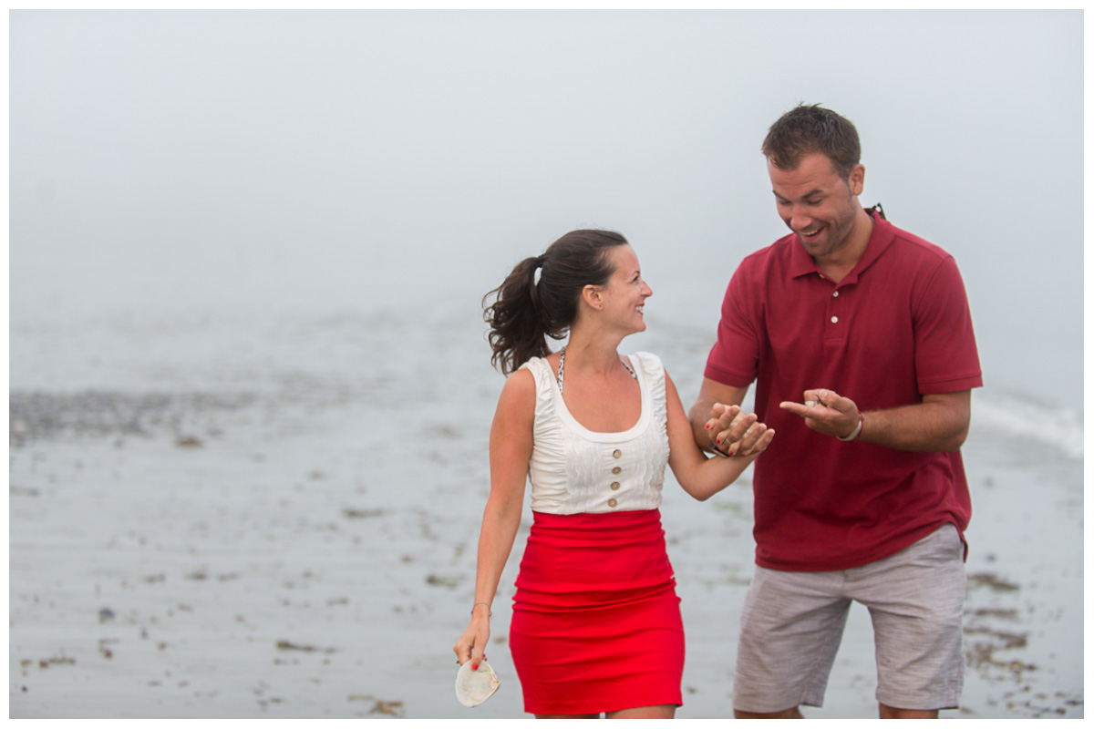 excitement over engagement ring on the beach