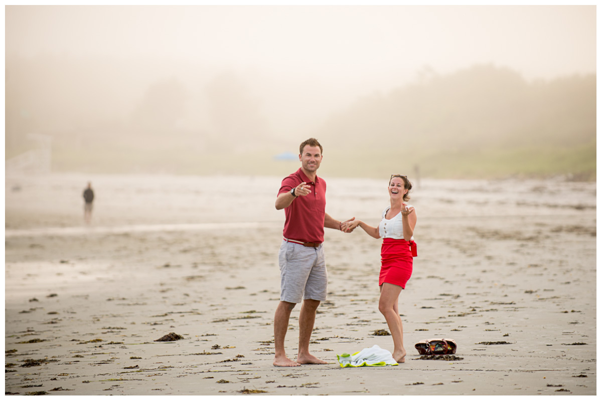 happy couple on the beach after proposal 
