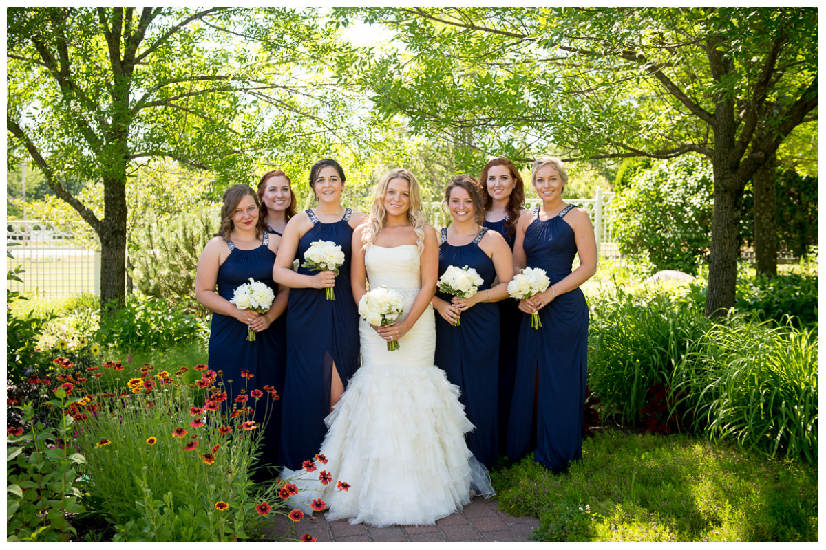 bridesmaids with bride in garden at Pineland Farms