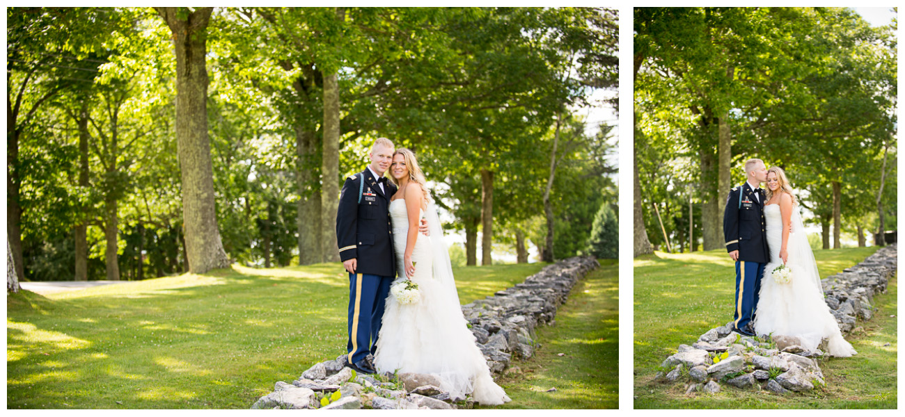 bride and groom standing on rock wall 