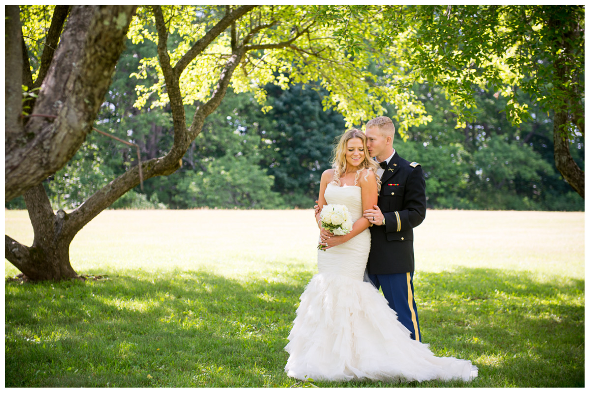 beautiful bride with groom under trees on a farm 