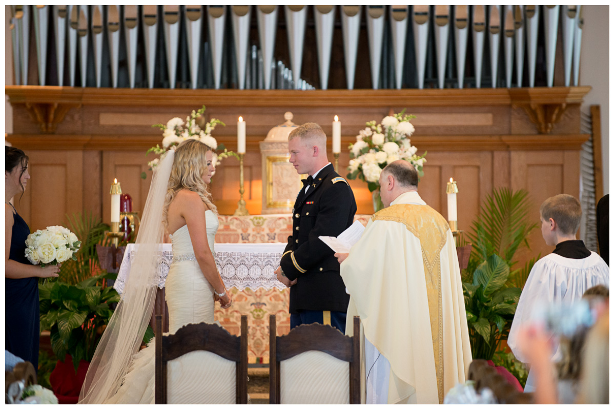 bride and groom saying vows in catholic church