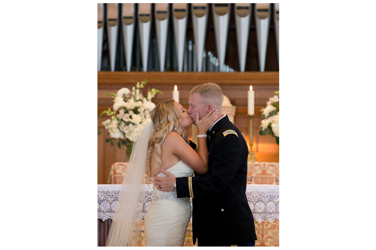 bride and groom kissing in church