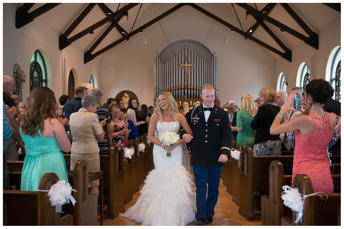 exciting bride and groom walking down the aisle 