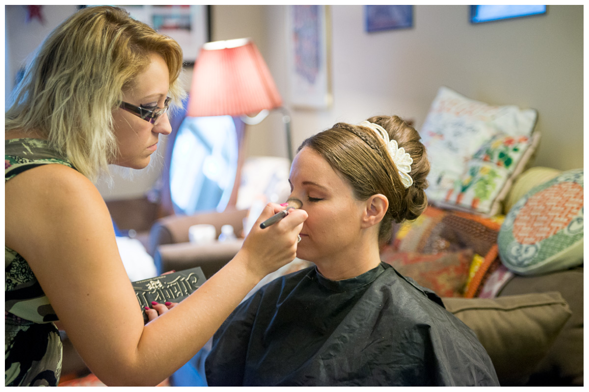 bride getting hair and make up down on wedding day