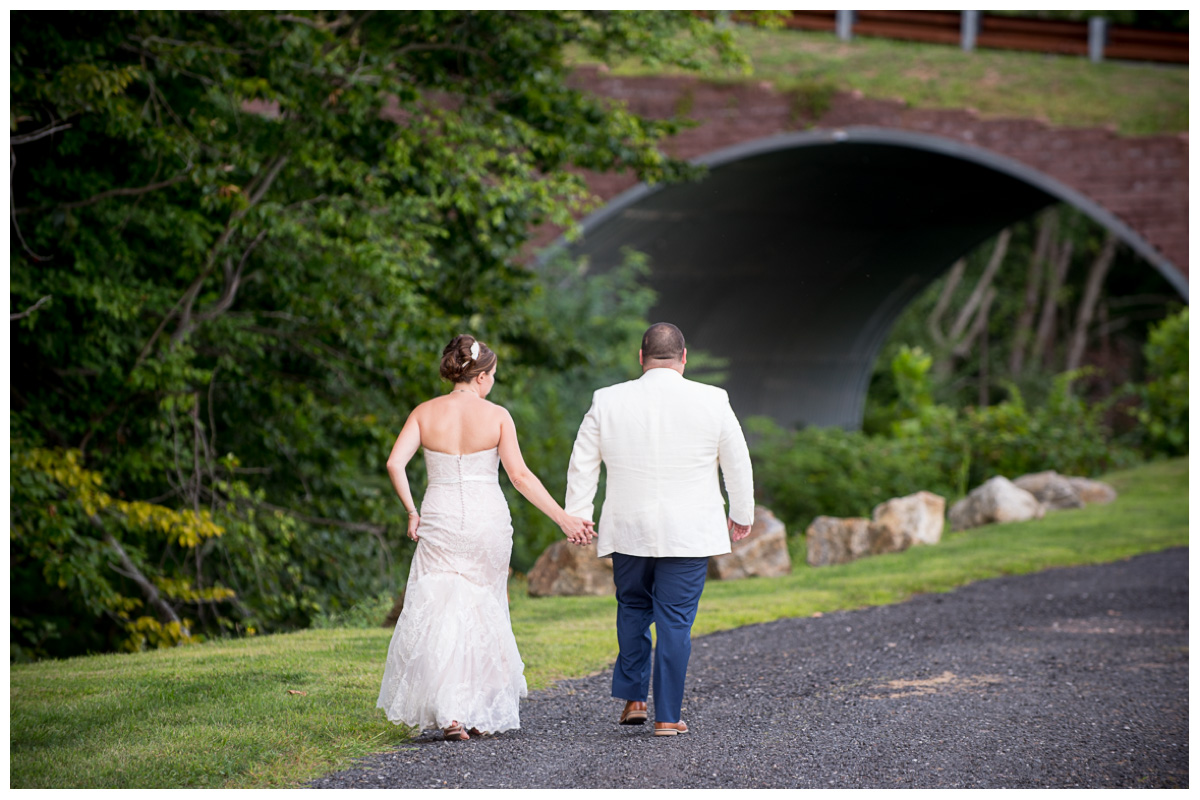 Happy couple walking hand in hand at wedding