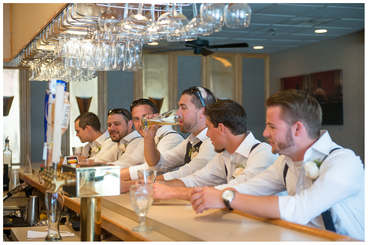 groomsmen in bar having fun on wedding day