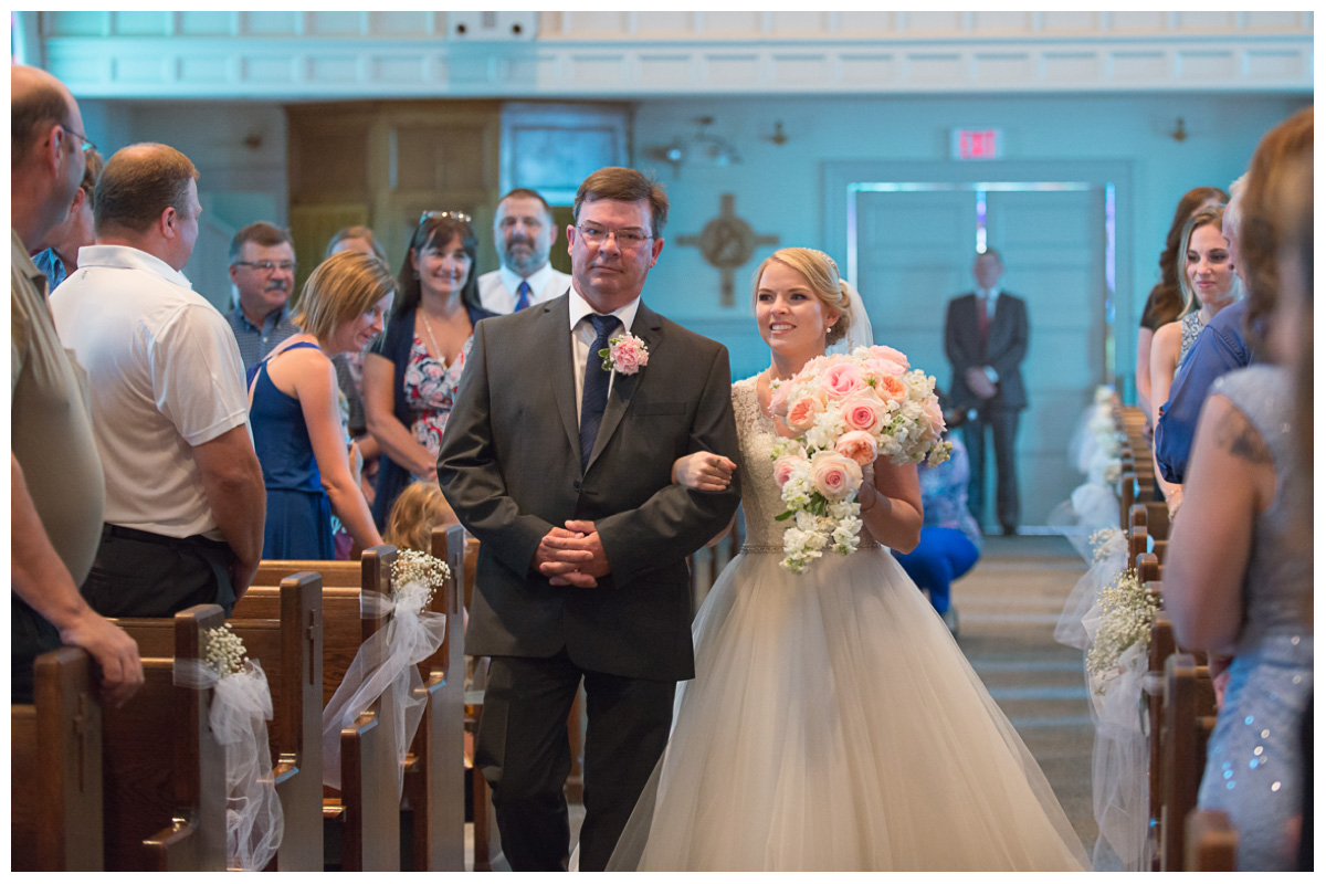 bride walking down the aisle on wedding day in church