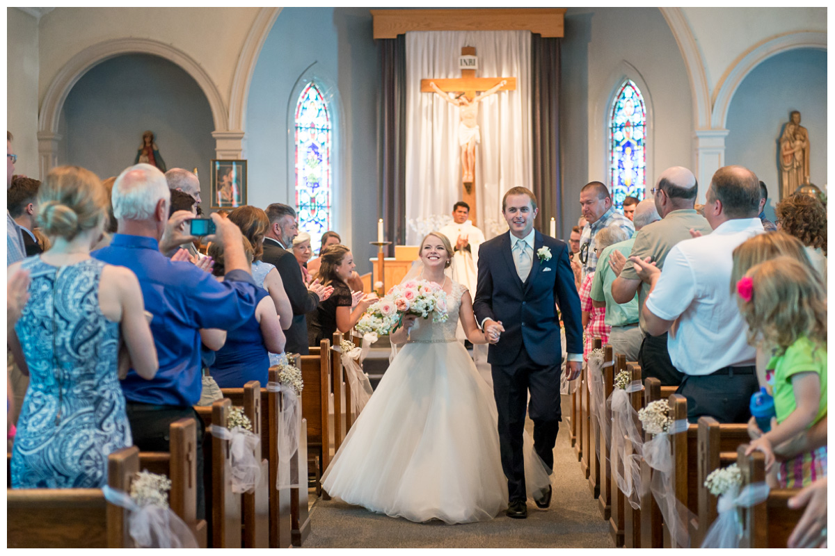 bride and groom walking down aisle in church