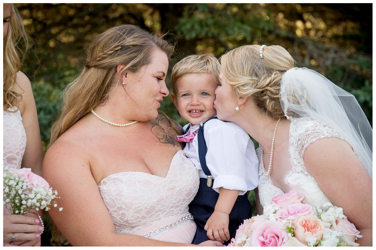 ring bearer dressed in suspenders and bow tie 