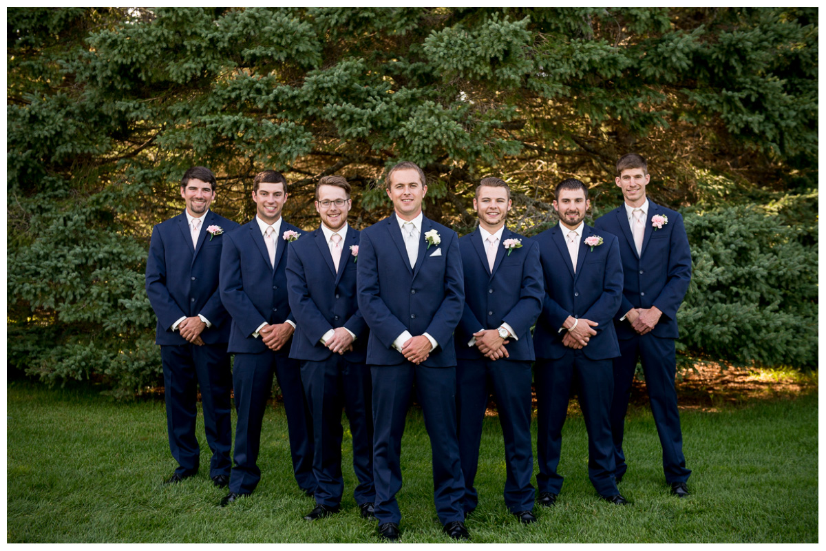 groommen's in navy blue suits with pink ties