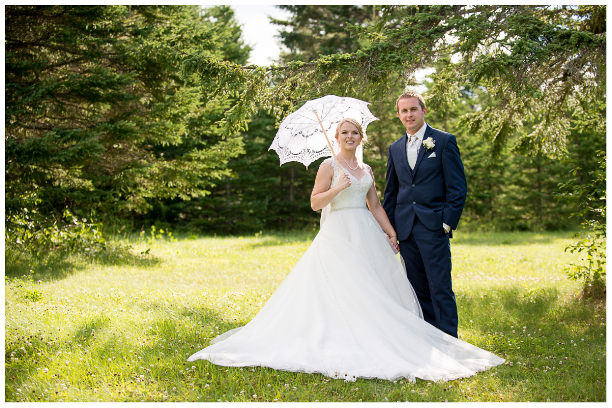 bride and groom in grassy maine field 