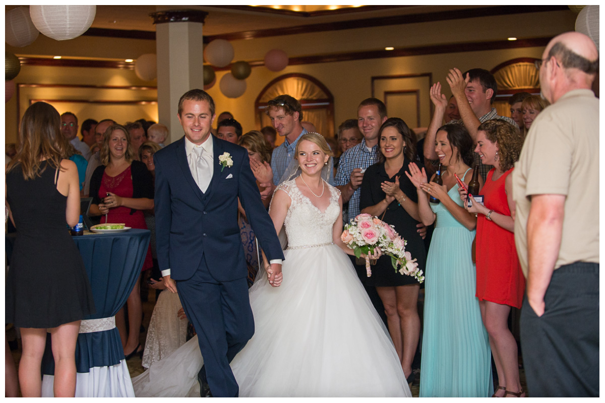 excited couple introduced at wedding reception