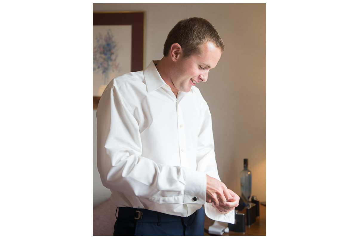 groom getting dressed on wedding day