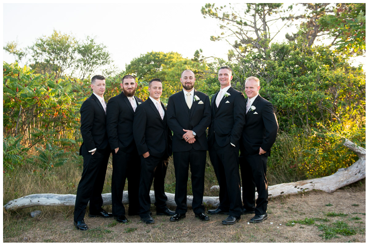 groom with groomsmen at the beach