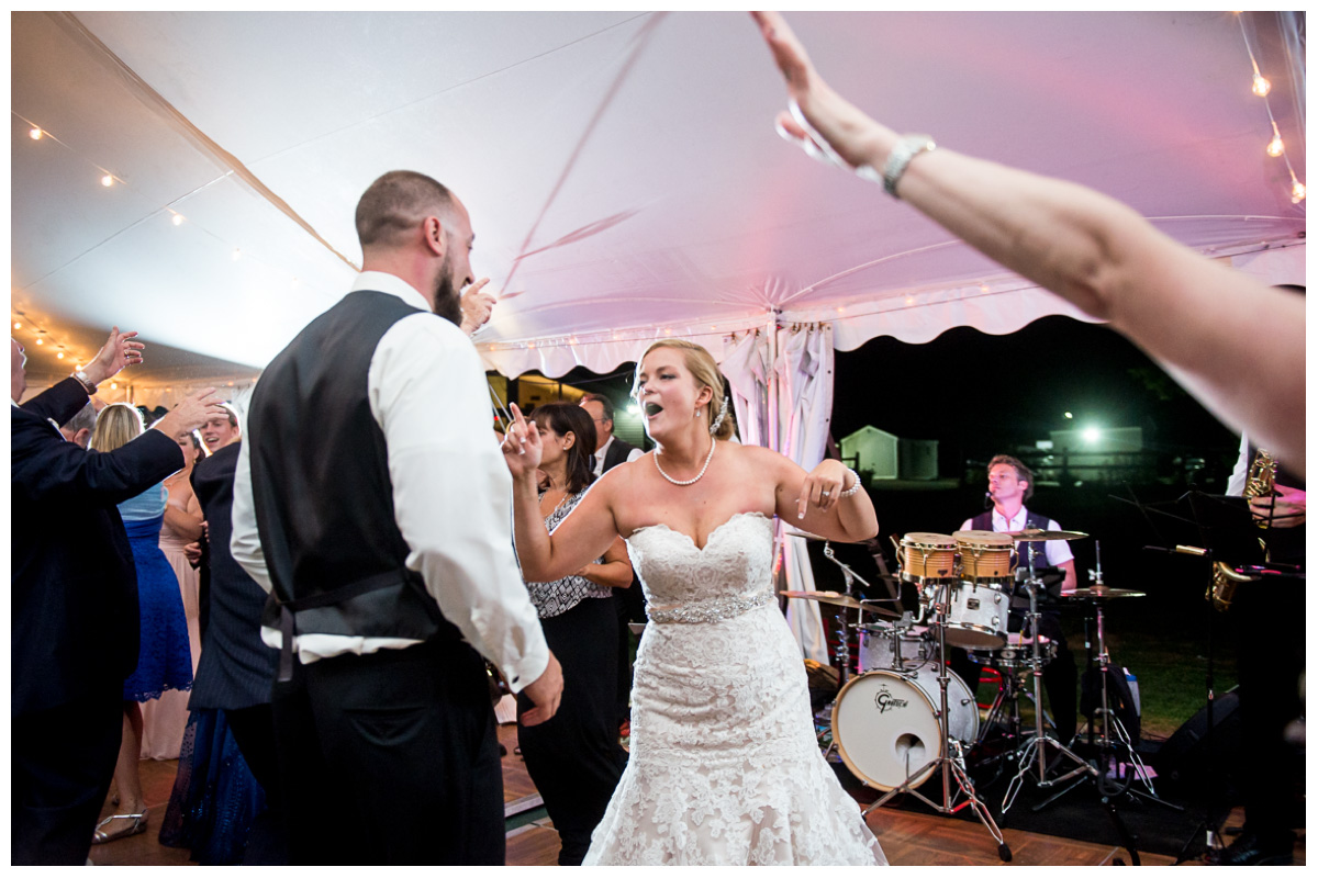 bride and groom dancing with live band during wedding reception