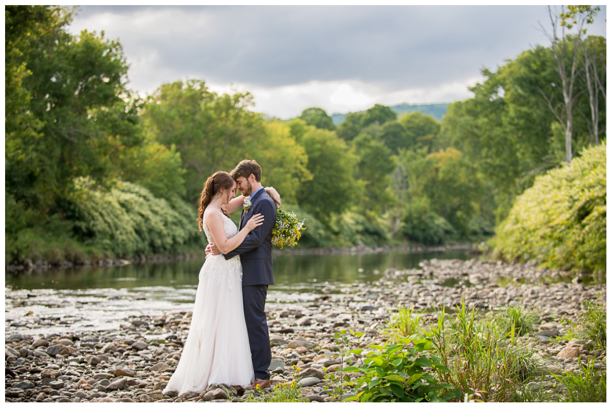 couple standing in riverbed in New England 