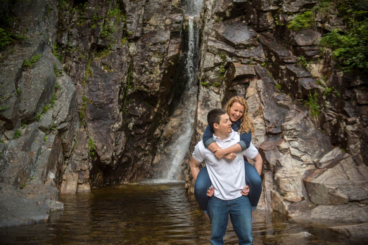 couple laughing during engagement photos waterfall, new hampshire mountain wedding photographer 