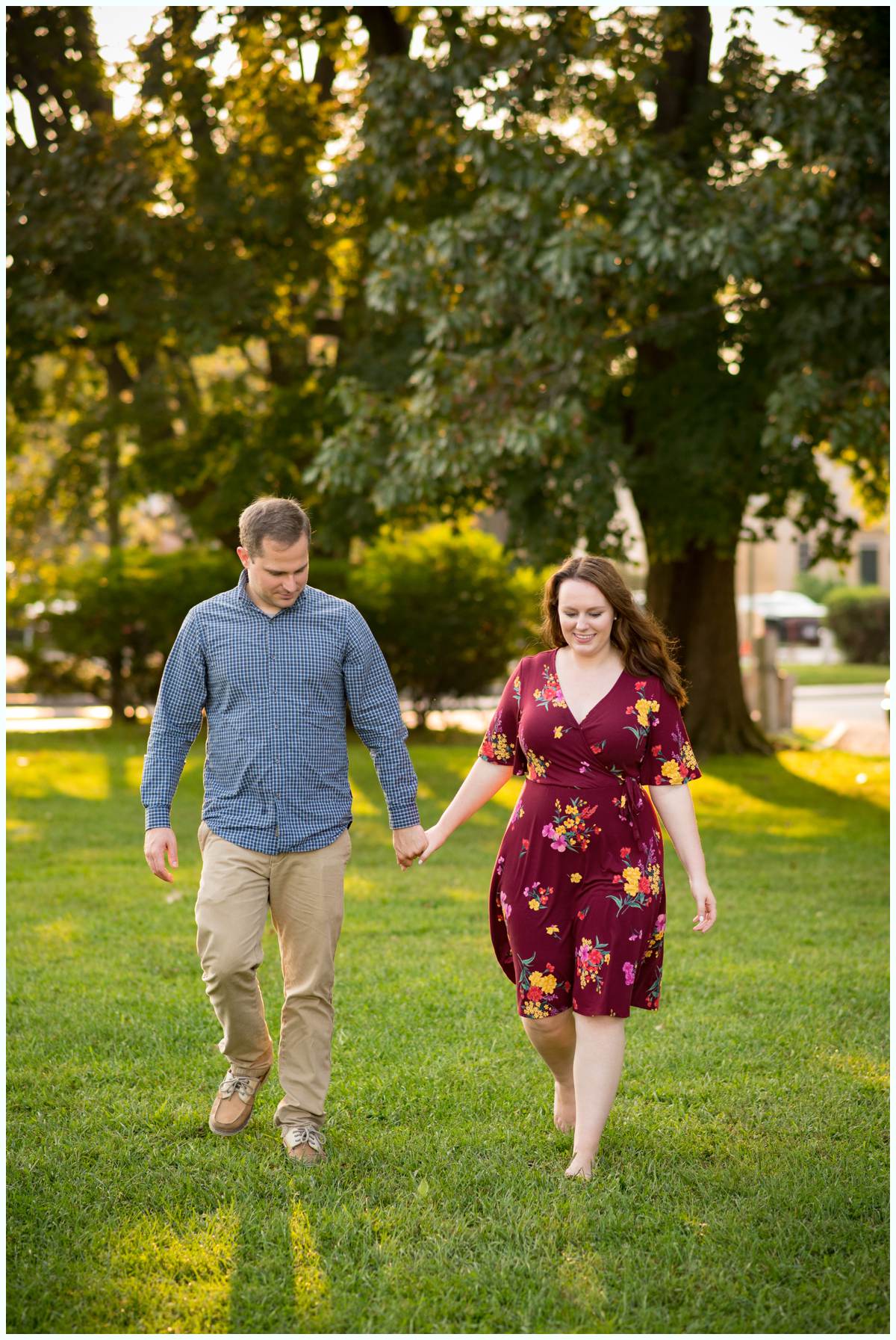 couple walking hand in hand for engagement photos in the summer in Portsmouth